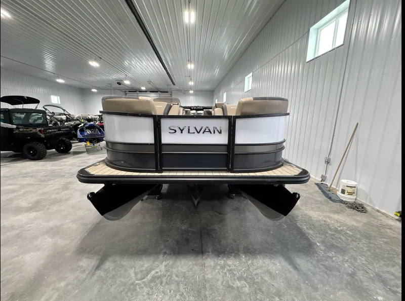 Slide: The Image of 2024 Sylvan L3 RLZ pontoon boat in a spacious indoor showroom. - 2