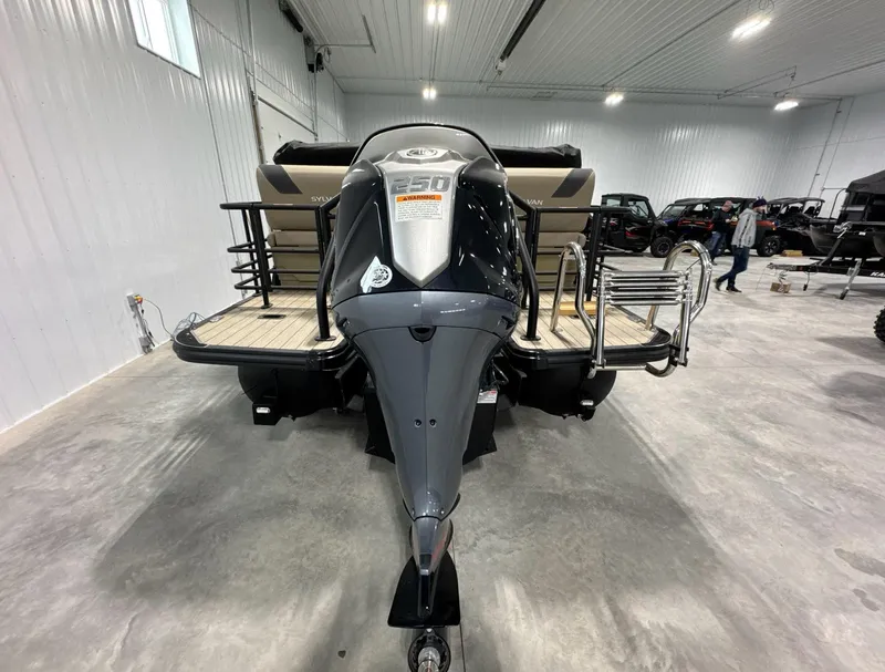 Slide: The Image of 2024 Sylvan L3 RLZ boat in showroom, rear view with powerful engine. - 3