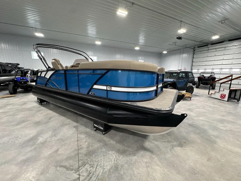 Slide: The Image of 2024 Sylvan Mirage X X3 CLZ DH pontoon boat in a spacious indoor showroom. - 10