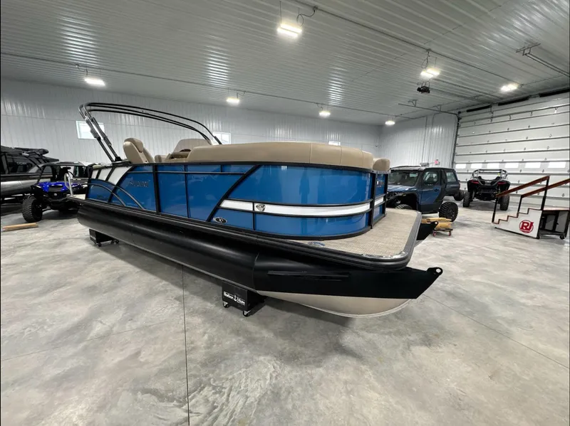 Slide: The Image of 2024 Sylvan Mirage X X3 CLZ DH pontoon boat in a spacious indoor showroom. - 3