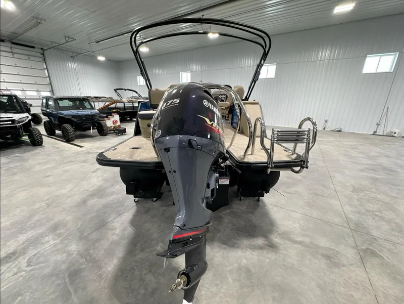 Slide: The Image of 2024 Sylvan Mirage X X3 CLZ DH pontoon boat with outboard motor in a showroom. - 5