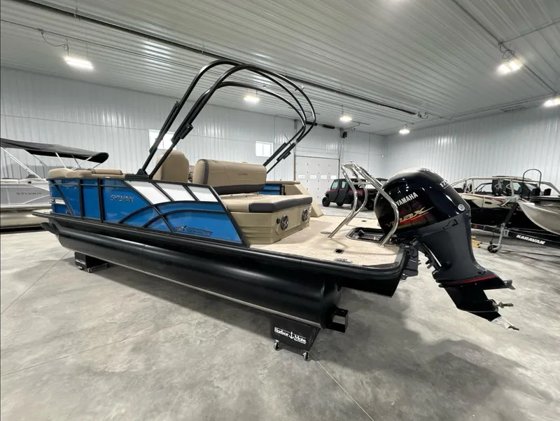 Slide: The Image of 2024 Sylvan Mirage X X3 CLZ DH pontoon boat in showroom, featuring Yamaha outboard motor. - 6
