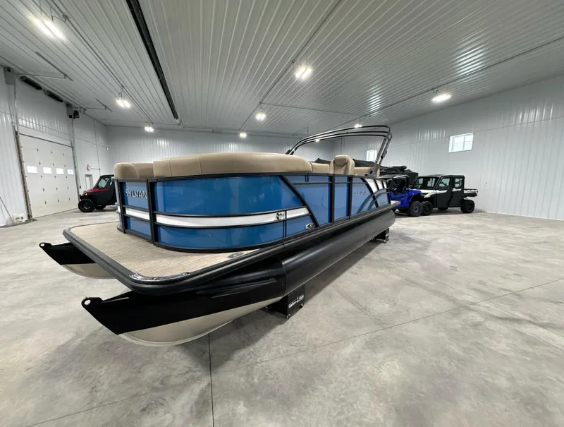 Slide: The Image of 2024 Sylvan Mirage X X3 CLZ DH pontoon boat in a spacious indoor showroom. - 8