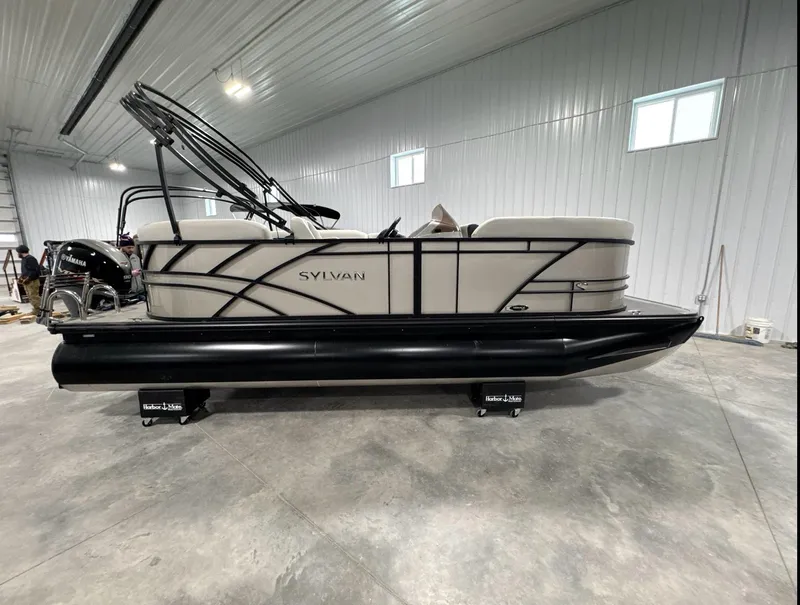 Slide: The Image of 2024 Sylvan Mirage 820 LZ pontoon boat in a spacious indoor setting. - 0