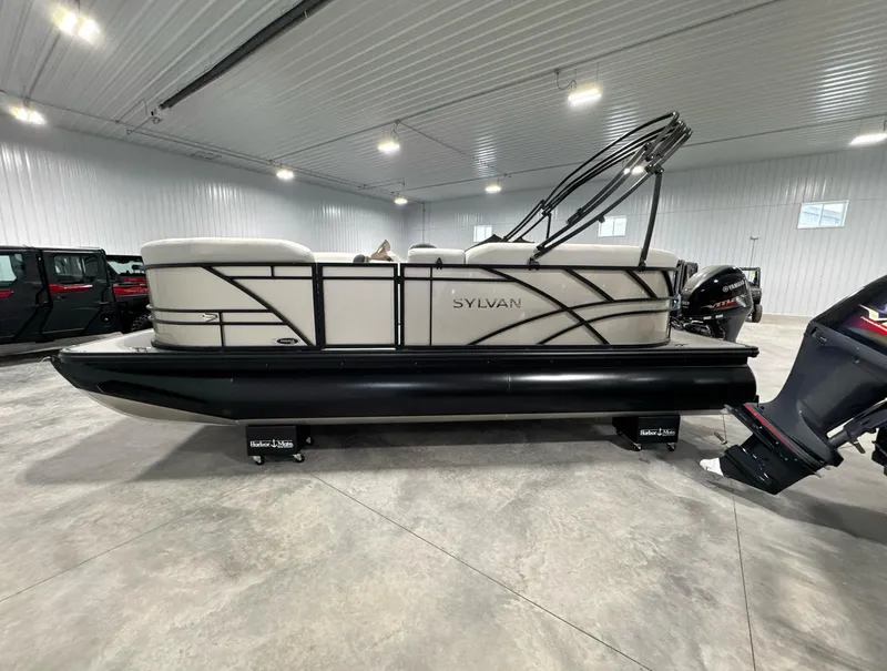 Slide: The Image of 2024 Sylvan Mirage 820 LZ pontoon boat with change room in a showroom. - 7