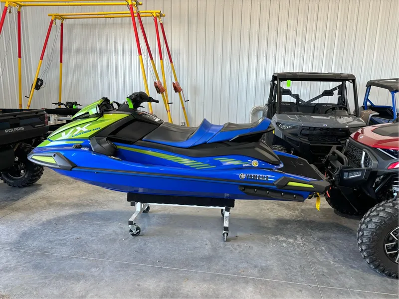 Slide: The Image of 2024 Yamaha WaveRunner VX Limited Ho in a showroom, blue and green design. - 2