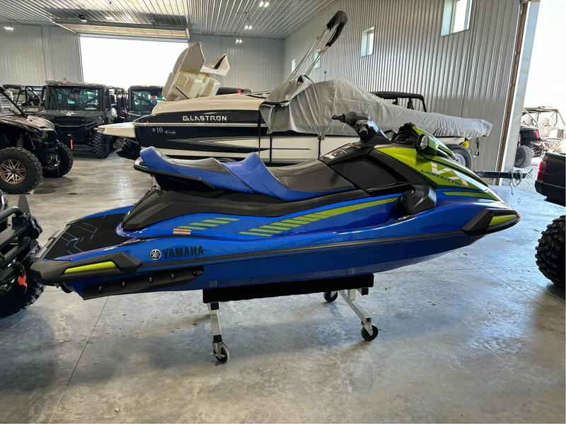 Slide: The Image of 2024 Yamaha WaveRunner VX Limited Ho in showroom, blue and green design. - 5
