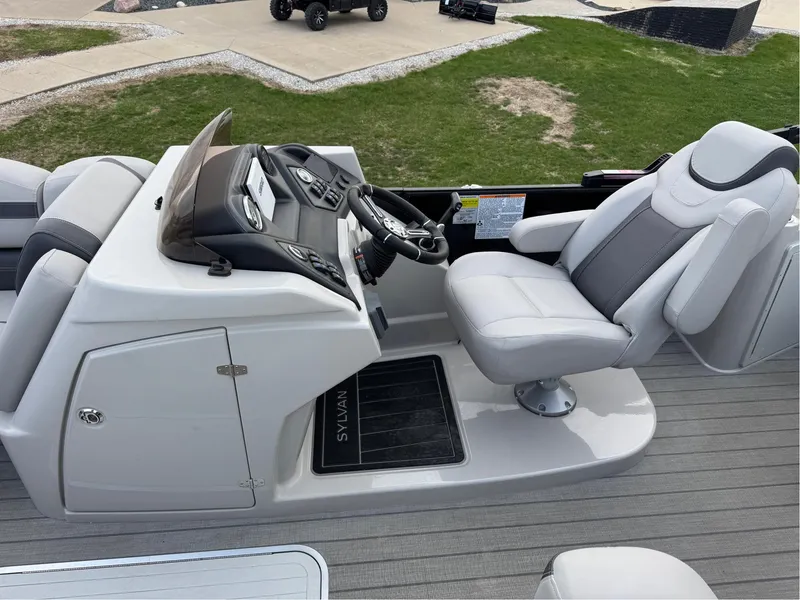 Slide: The Image of 2023 Sylvan L5 DLZ Bar boat interior with modern helm and comfortable seating. - 8