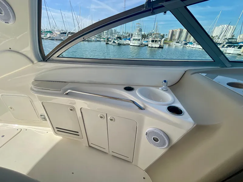 Slide: The Image of 2001 Sea Ray 340 Sundancer interior with sink and storage, marina view. - 11
