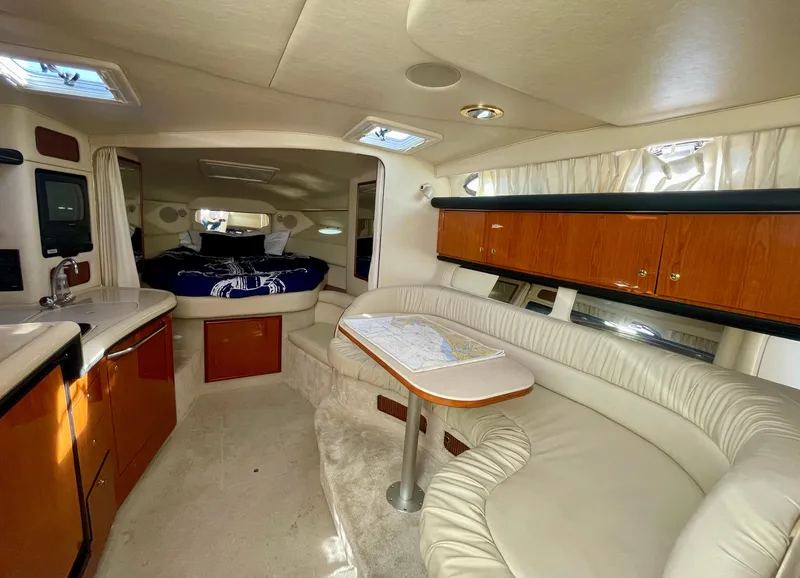 Slide: The Image of Interior of 2001 Sea Ray 340 Sundancer yacht with cozy seating and elegant wood cabinetry. - 17