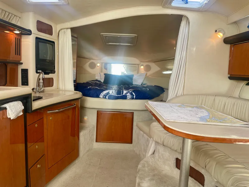 Slide: The Image of Interior of 2001 Sea Ray 340 Sundancer yacht with cozy cabin and kitchenette. - 19