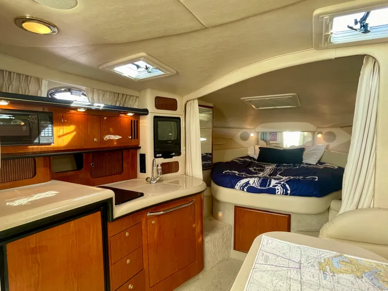 Slide: The Image of Interior of 2001 Sea Ray 340 Sundancer yacht with cozy cabin and kitchenette. - 20