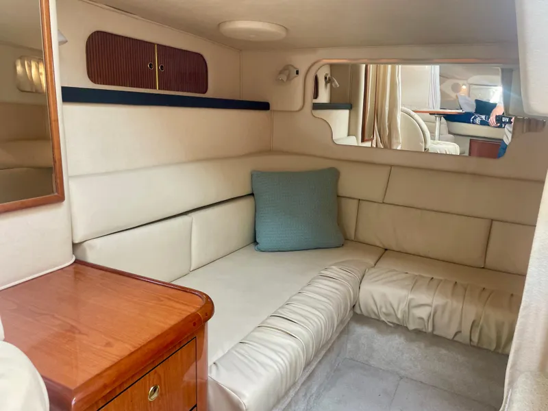 Slide: The Image of Interior of 2001 Sea Ray 340 Sundancer with beige seating and wooden accents. - 24