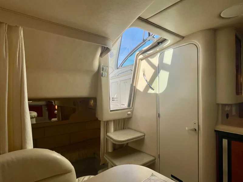 Slide: The Image of Interior of 2001 Sea Ray 340 Sundancer yacht, featuring cozy seating and natural light. - 26