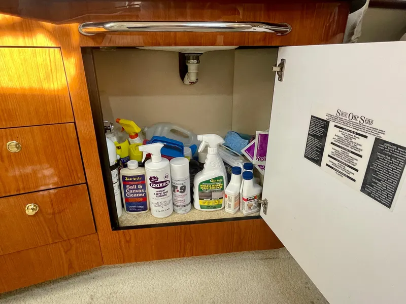Slide: The Image of Open cabinet on 2001 Sea Ray 340 Sundancer with cleaning supplies inside. - 29