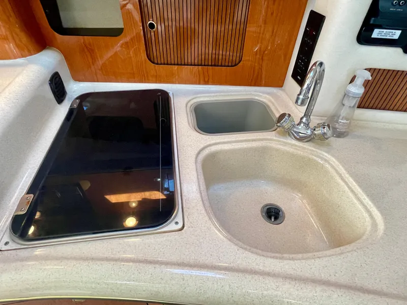Slide: The Image of 2001 Sea Ray 340 Sundancer kitchen area with dual sinks and stovetop. - 30