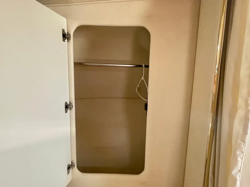 Slide: The Image of Empty closet inside 2001 Sea Ray 340 Sundancer boat, featuring open door and hanging rod. - 35