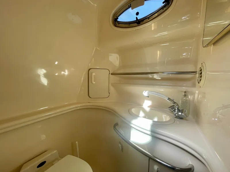 Slide: The Image of 2001 Sea Ray 340 Sundancer bathroom with sink, porthole, and storage. - 36