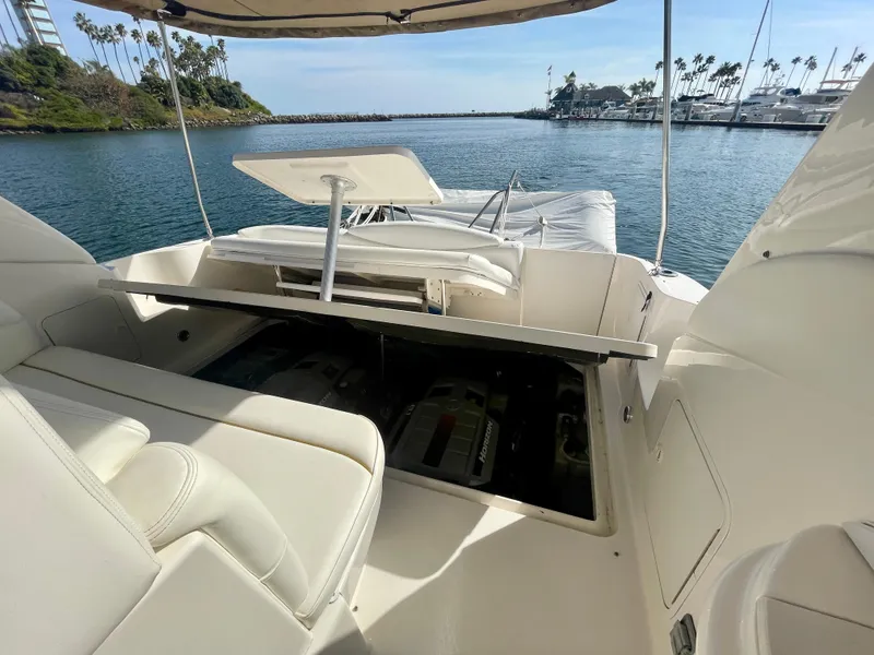 Slide: The Image of 2001 Sea Ray 340 Sundancer boat interior with open engine compartment, docked in a scenic marina. - 39