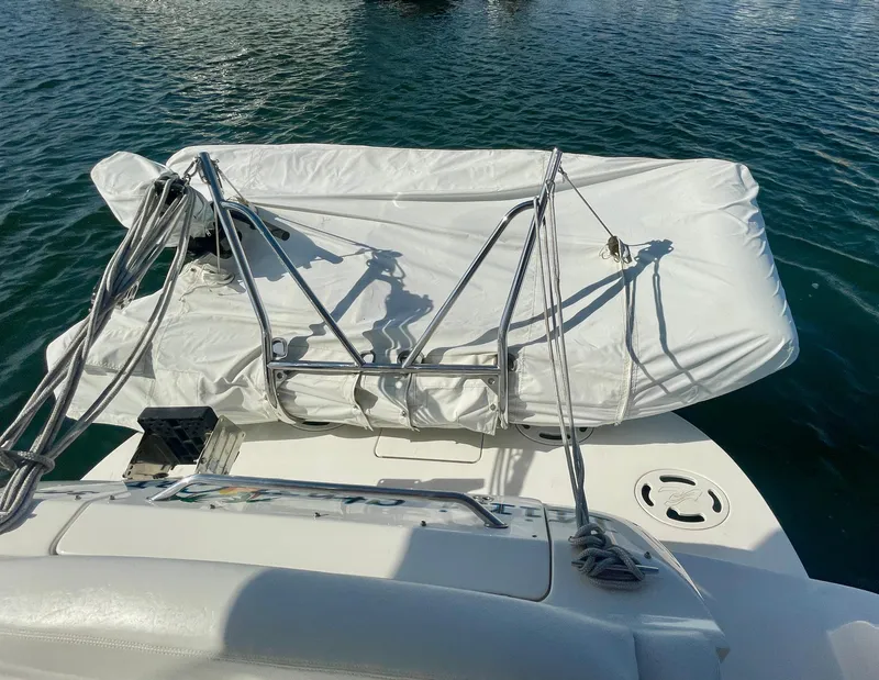 Slide: The Image of 2001 Sea Ray 340 Sundancer with covered equipment on deck, floating on water. - 41