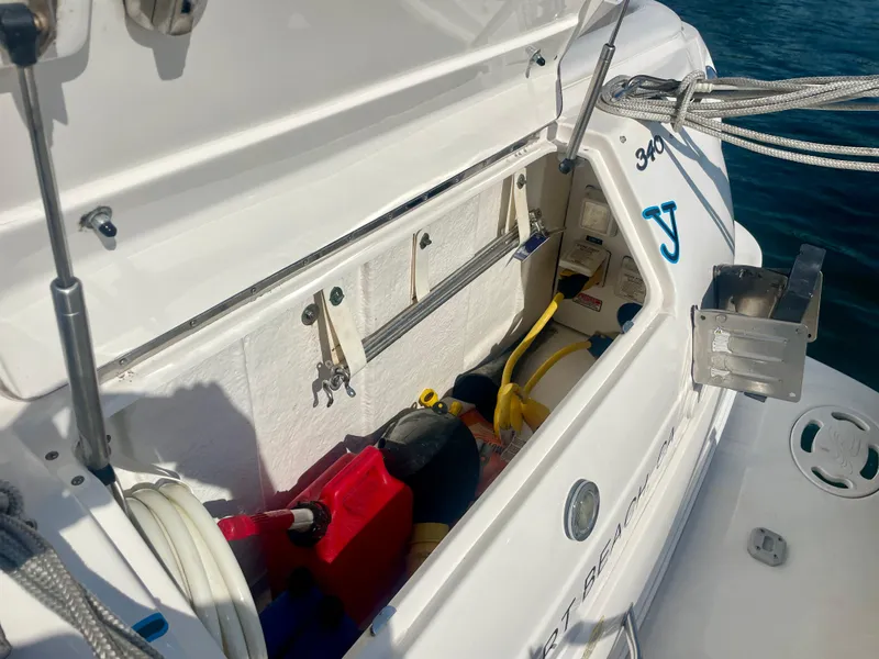 Slide: The Image of Storage compartment of a 2001 Sea Ray 340 Sundancer boat, containing various equipment. - 43