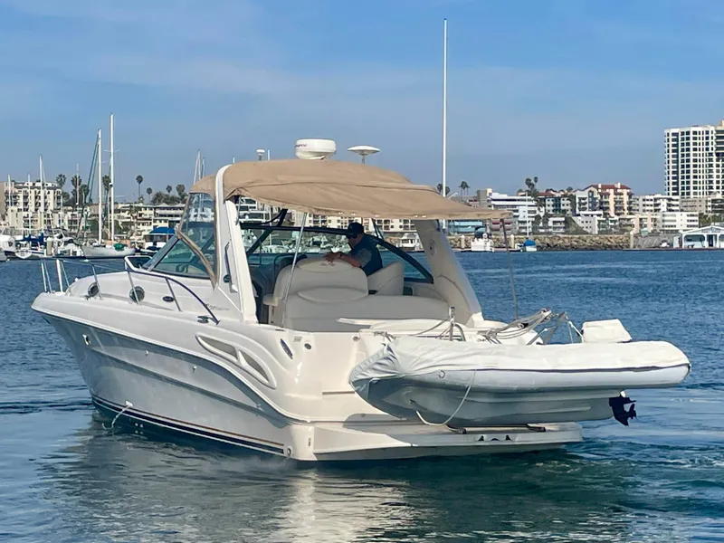 Slide: The Image of 2001 Sea Ray 340 Sundancer yacht with dinghy, docked in a marina. - 6