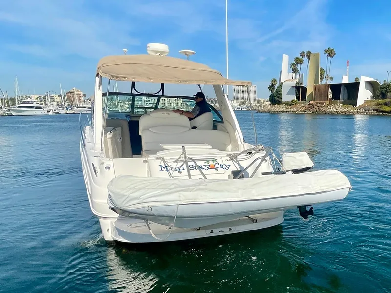 Slide: The Image of 2001 Sea Ray 340 Sundancer yacht cruising in a marina with clear blue skies. - 7