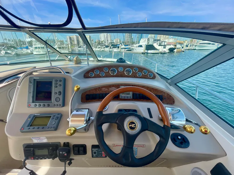Slide: The Image of Cockpit of 2001 Sea Ray 340 Sundancer with steering wheel and navigation equipment. - 8