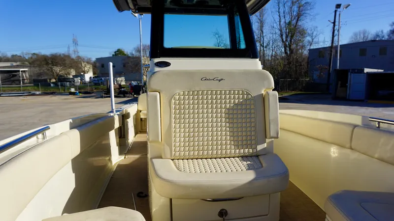 Slide: The Image of 2021 Chris-Craft Catalina 27 boat interior with cushioned seating and helm station. - 13