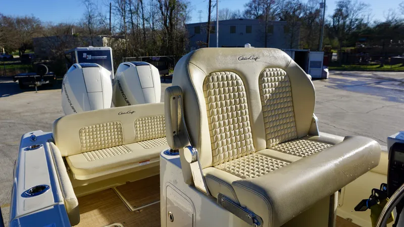 Slide: The Image of 2021 Chris-Craft Catalina 27 boat interior with beige seating and dual engines. - 15