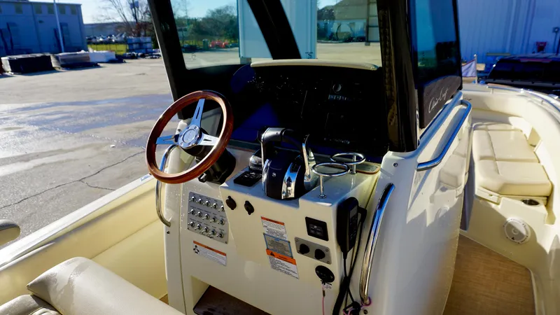Slide: The Image of 2021 Chris-Craft Catalina 27 helm with steering wheel and control panel. - 17