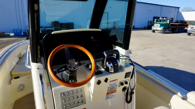 Slide: The Image of 2021 Chris-Craft Catalina 27 helm with wooden steering wheel and control panel. - 18