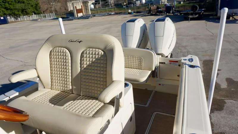 Slide: The Image of 2021 Chris-Craft Catalina 27 boat with beige seating and dual engines. - 19