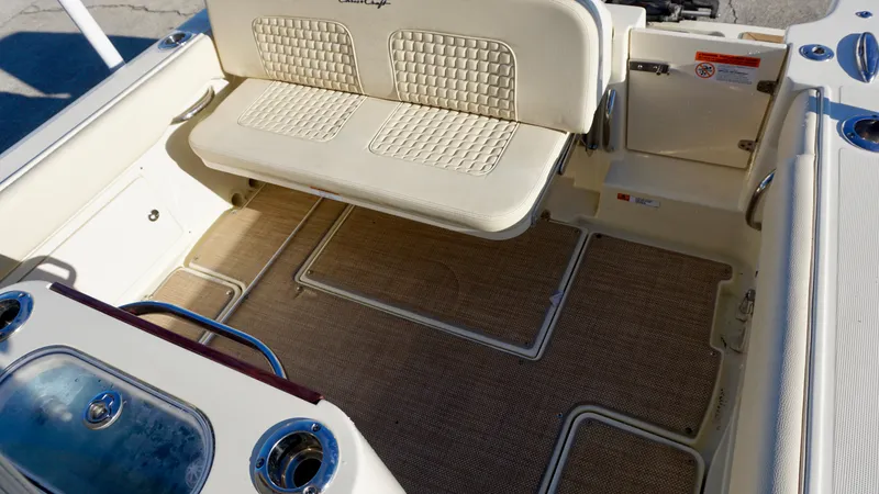 Slide: The Image of 2021 Chris-Craft Catalina 27 boat interior with cushioned seating and deck flooring. - 20