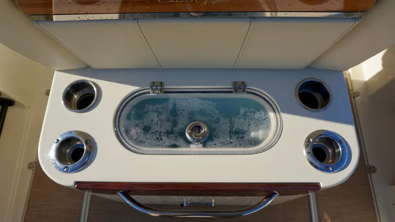 Slide: The Image of Livewell on 2021 Chris-Craft Catalina 27 boat, featuring multiple cup holders. - 22