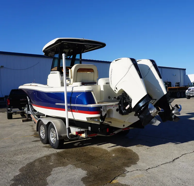 Slide: The Image of 2021 Chris-Craft Catalina 27 boat on trailer, dual engines, blue and white design. - 5