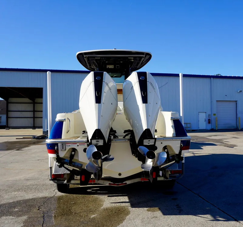 Slide: The Image of 2021 Chris-Craft Catalina 27 with dual outboard engines, parked outdoors. - 6