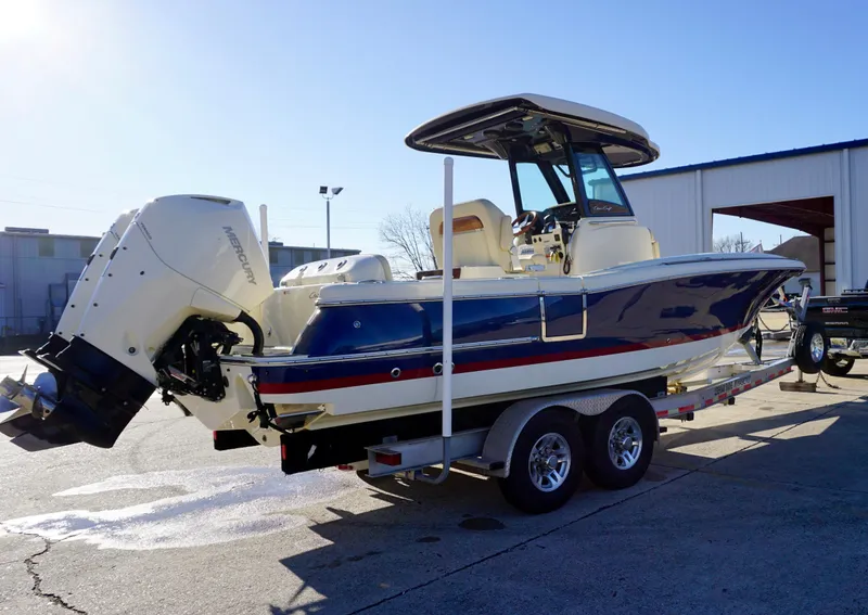 Slide: The Image of 2021 Chris-Craft Catalina 27 boat on trailer, parked outdoors, side view. - 8