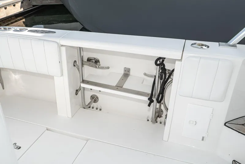 Slide: The Image of 2010 Intrepid 43 Sport Yacht deck storage area with ropes and fittings. - 14