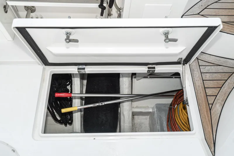Slide: The Image of Storage compartment on a 2010 Intrepid 43 Sport Yacht with tools and cables. - 17