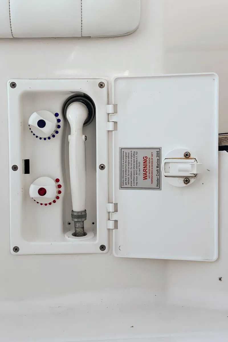 Slide: The Image of 2010 Intrepid 43 Sport Yacht shower controls with temperature dials and hose. - 19