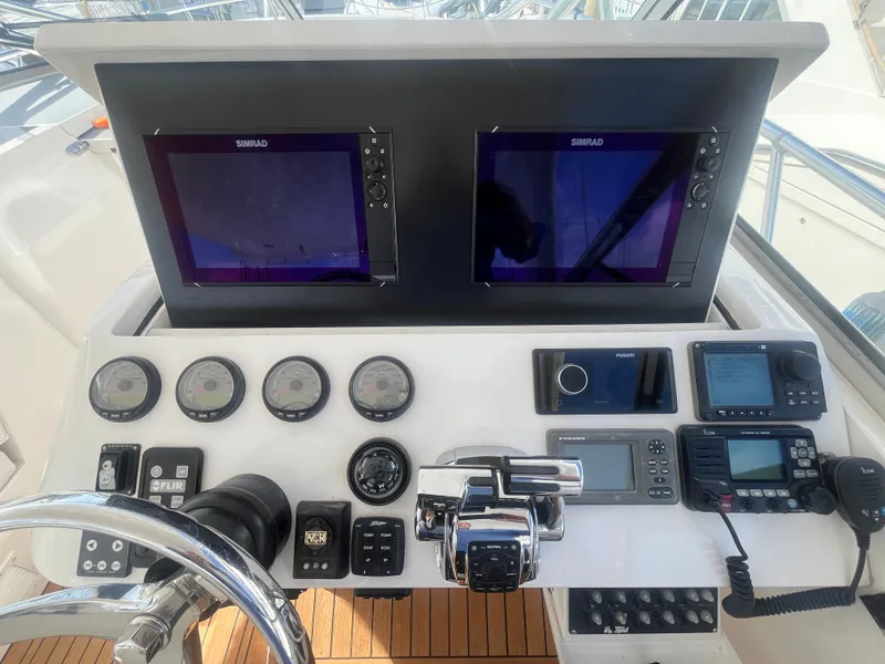 Slide: The Image of Control panel of a 2010 Intrepid 43 Sport Yacht with navigation screens and gauges. - 24