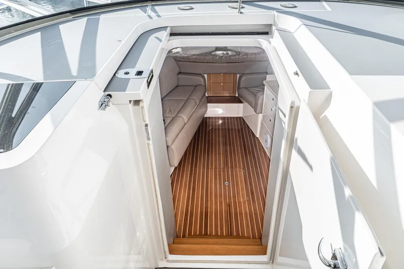 Slide: The Image of Interior view of 2010 Intrepid 43 Sport Yacht with sleek wood flooring and modern seating. - 25