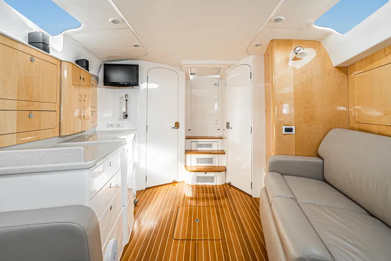 Slide: The Image of Interior of a 2010 Intrepid 43 Sport Yacht with modern furnishings and wood flooring. - 28