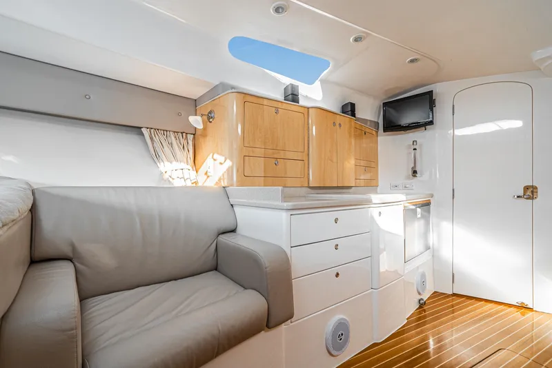 Slide: The Image of Interior of 2010 Intrepid 43 Sport Yacht with modern cabinetry and seating. - 29