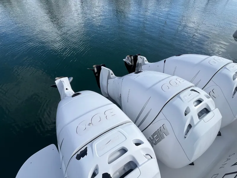 Slide: The Image of 2010 Intrepid 43 Sport Yacht with triple outboard engines on calm water. - 42