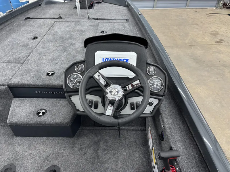 Slide: The Image of 2025 Ranger RT198P boat cockpit with steering wheel and Lowrance display. - 11