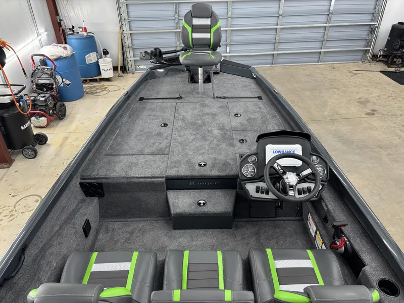 Slide: The Image of 2025 Ranger RT198P boat interior with gray and green seating, steering console, and storage compartments. - 12