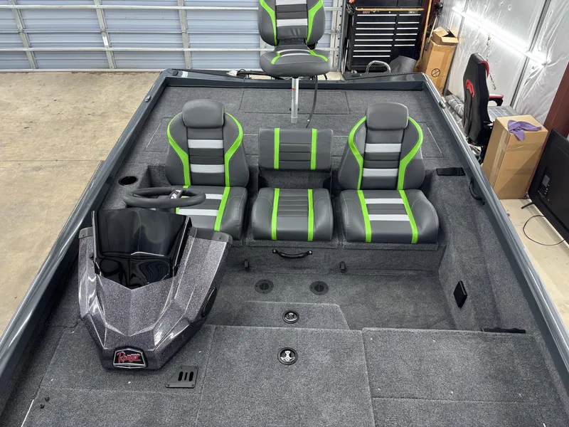 Slide: The Image of 2025 Ranger RT198P boat interior with gray and green seating, steering console, and spacious deck. - 14