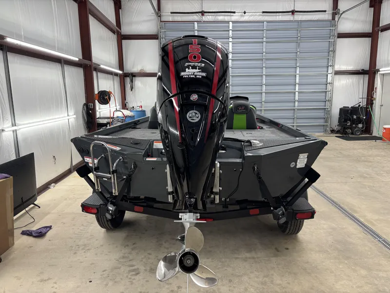 Slide: The Image of 2025 Ranger RT198P boat in garage, rear view with powerful outboard motor. - 9